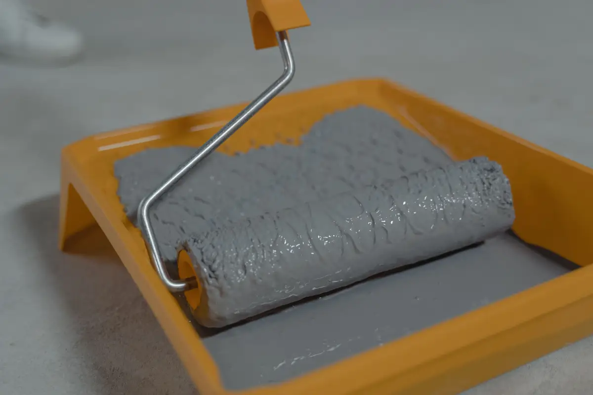 Close-up of gray epoxy floor coating and roller tray