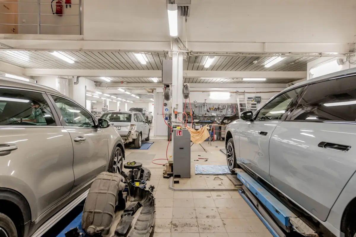 Auto repair shop bay with vehicle lifts and a coated floor