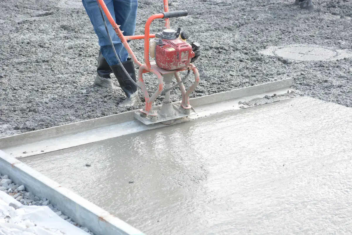 Concrete surface being finished with a power trowel tool