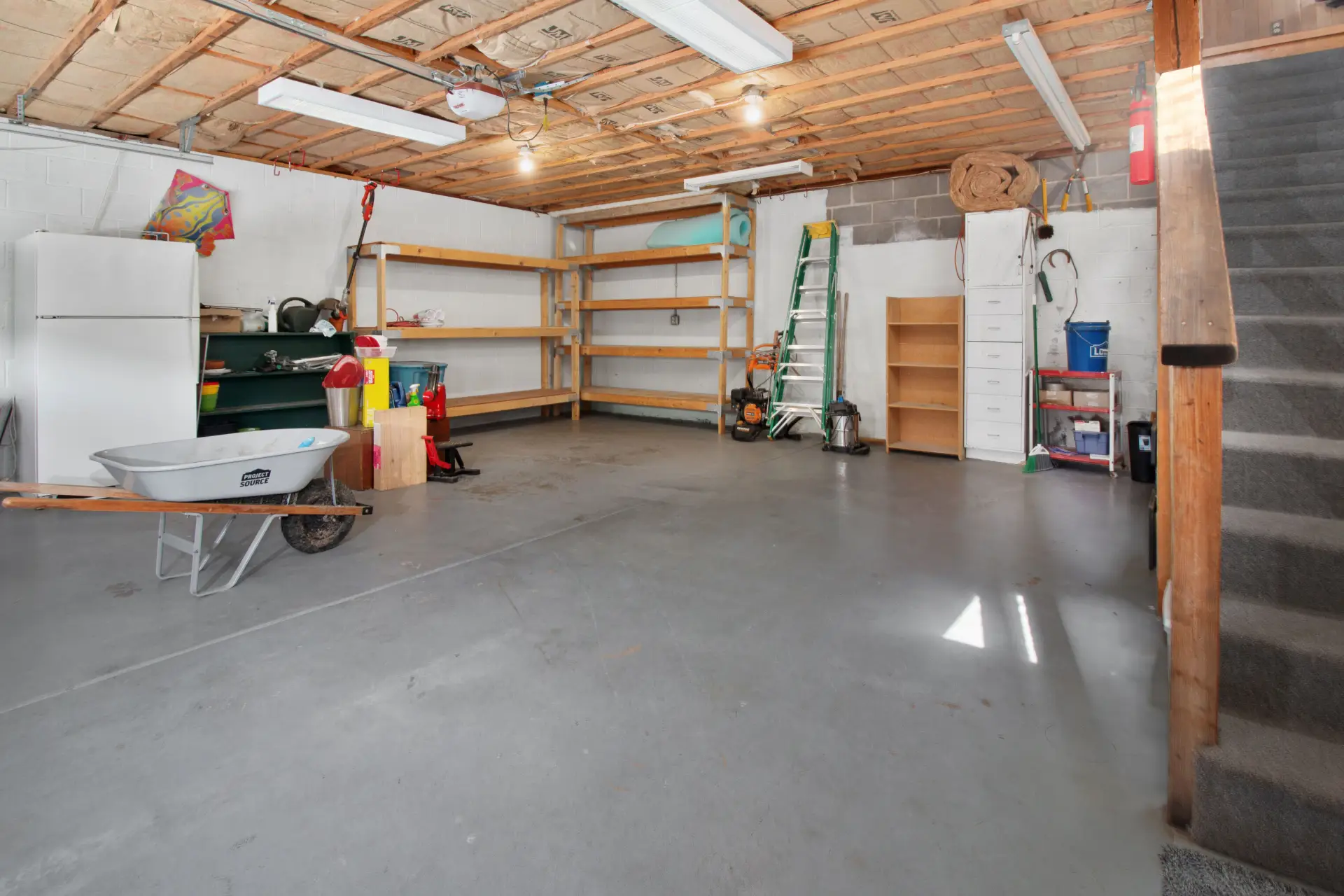 Clean residential garage interior with a bare concrete floor