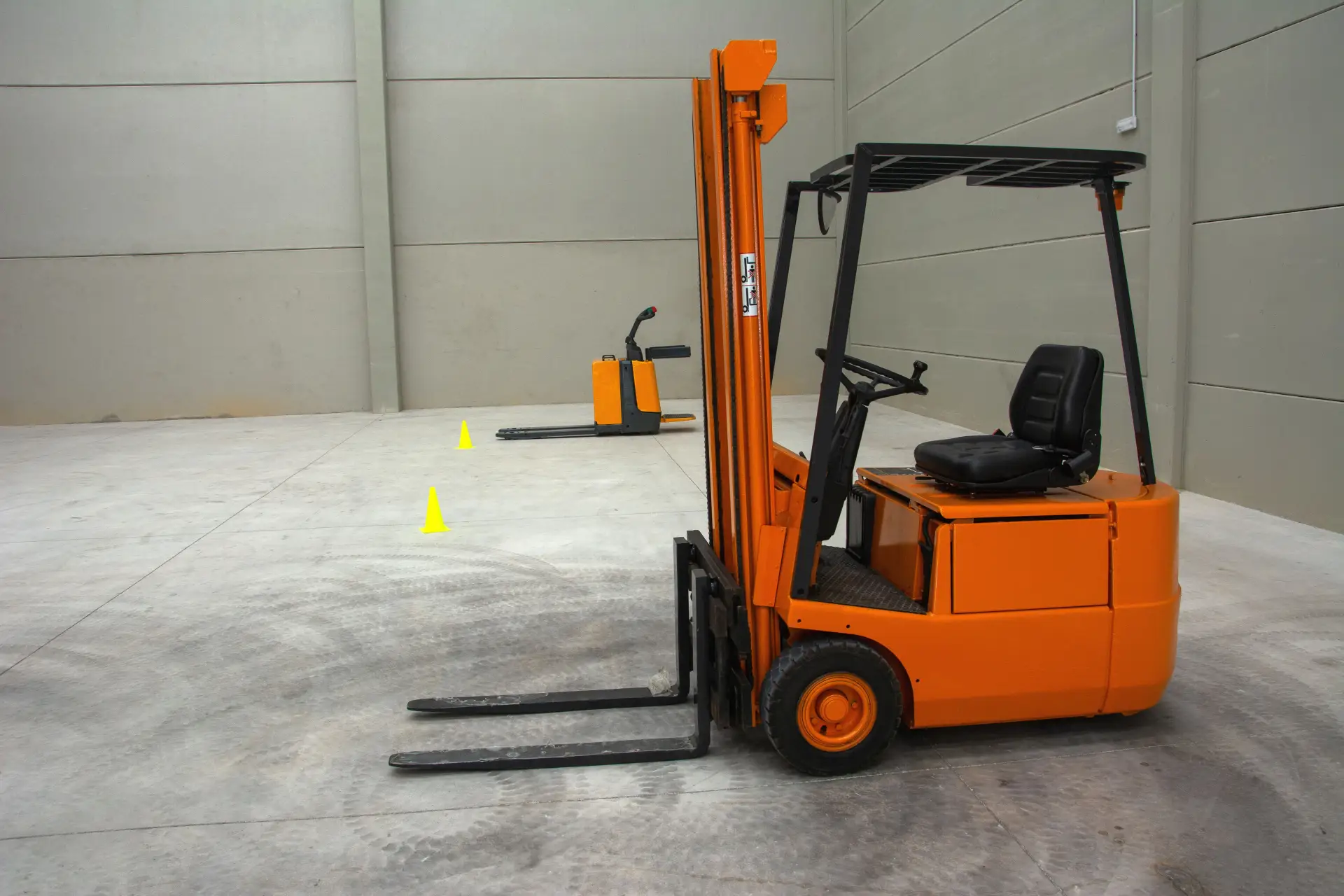 Forklift on a plain concrete warehouse floor