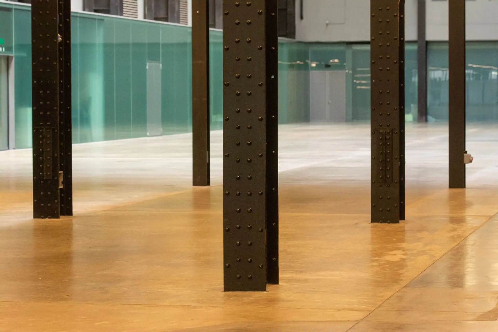 Amber-toned polished decorative floor with steel columns
