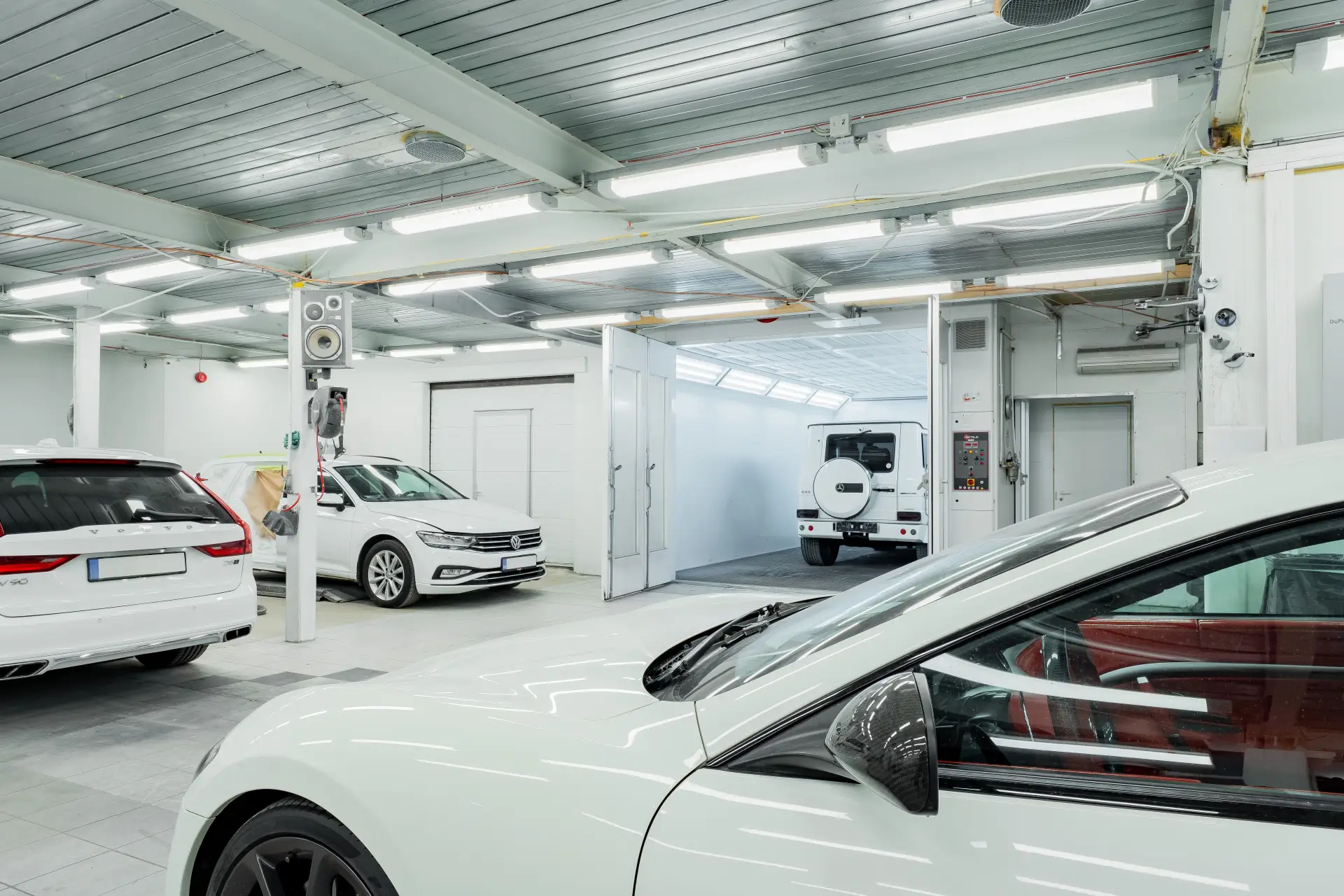 Bright auto body shop interior with a coated concrete floor