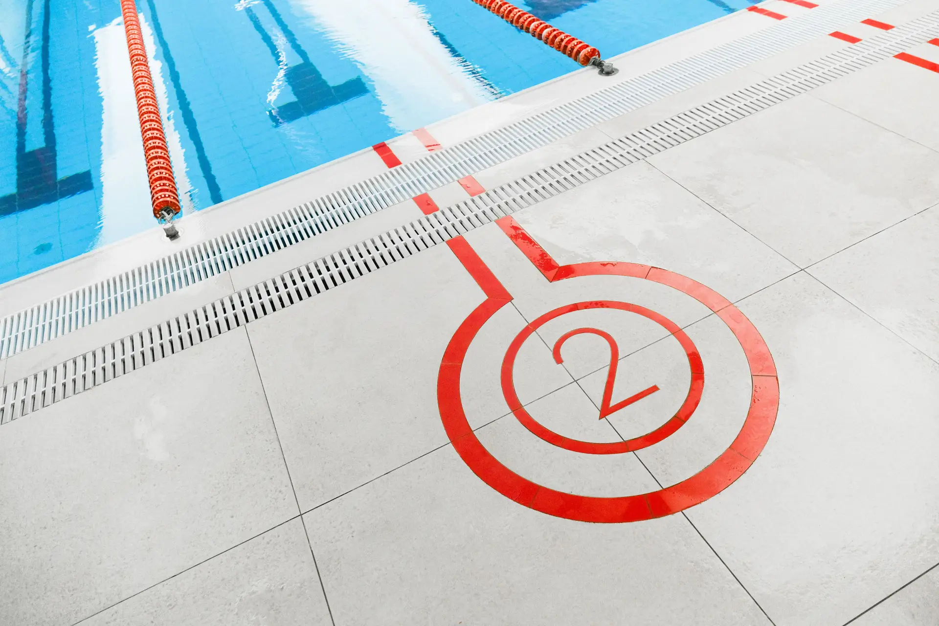 Smooth coated concrete pool deck with a painted lane marker