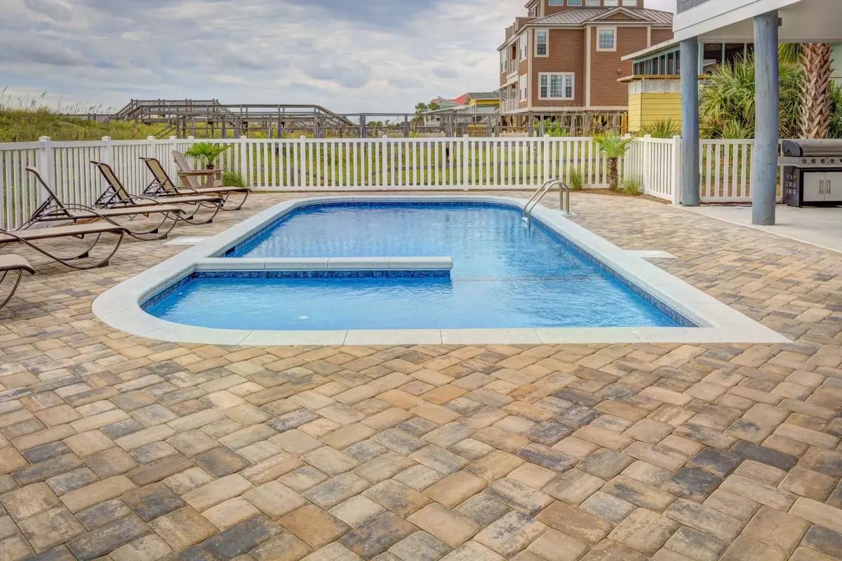 Finished in-ground pool with a deck and poolside seating area