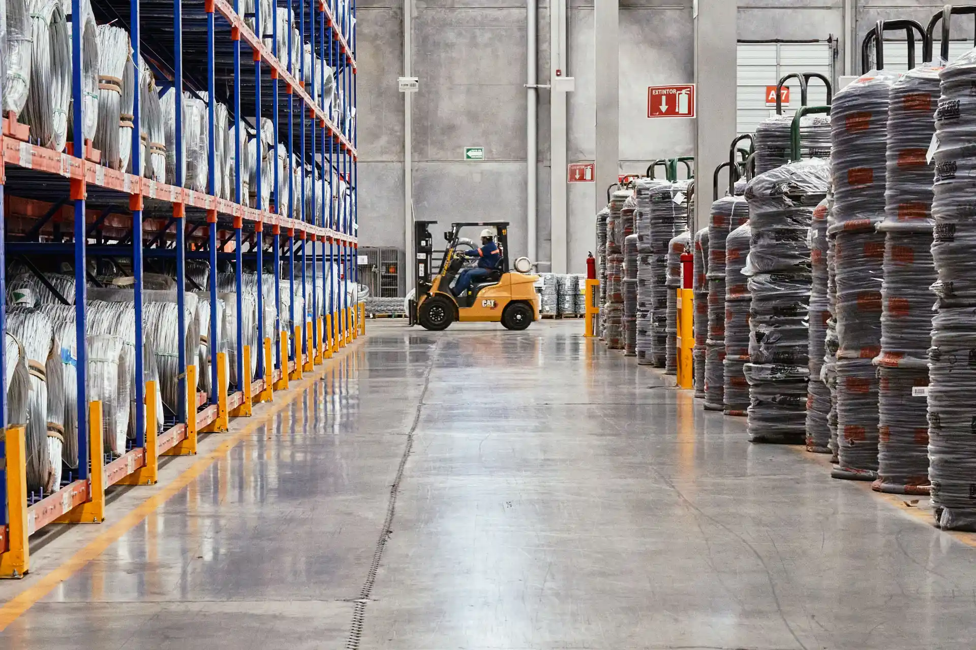 Distribution warehouse aisle with racking and a forklift